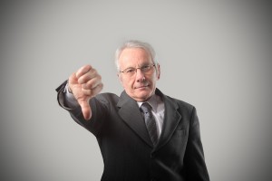 Portrait of a senior businessman with thumbs down