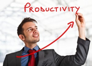 Friendly businessman writing the word Productivity and a rising arrow